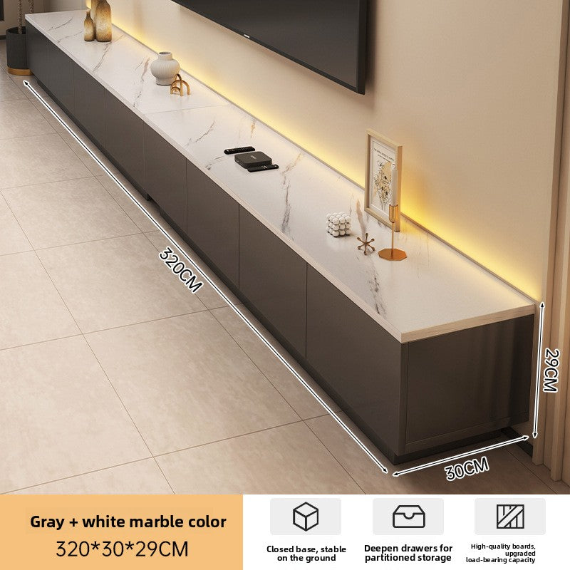 Low modern TV stand styled with warm neutral decor and a mounted screen