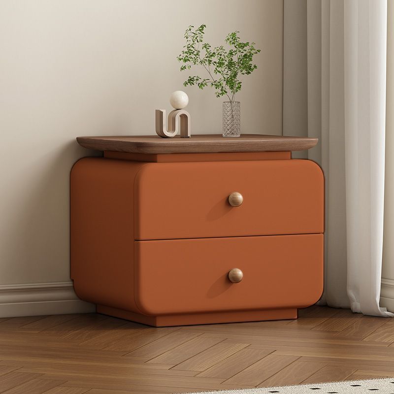 Compact upholstered nightstand with wood drawer in a neutral bedroom