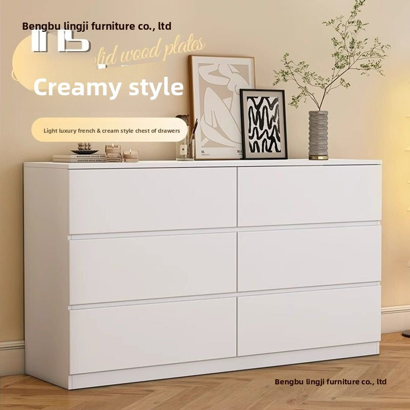 Detailed view of cream dresser drawers and rounded edges