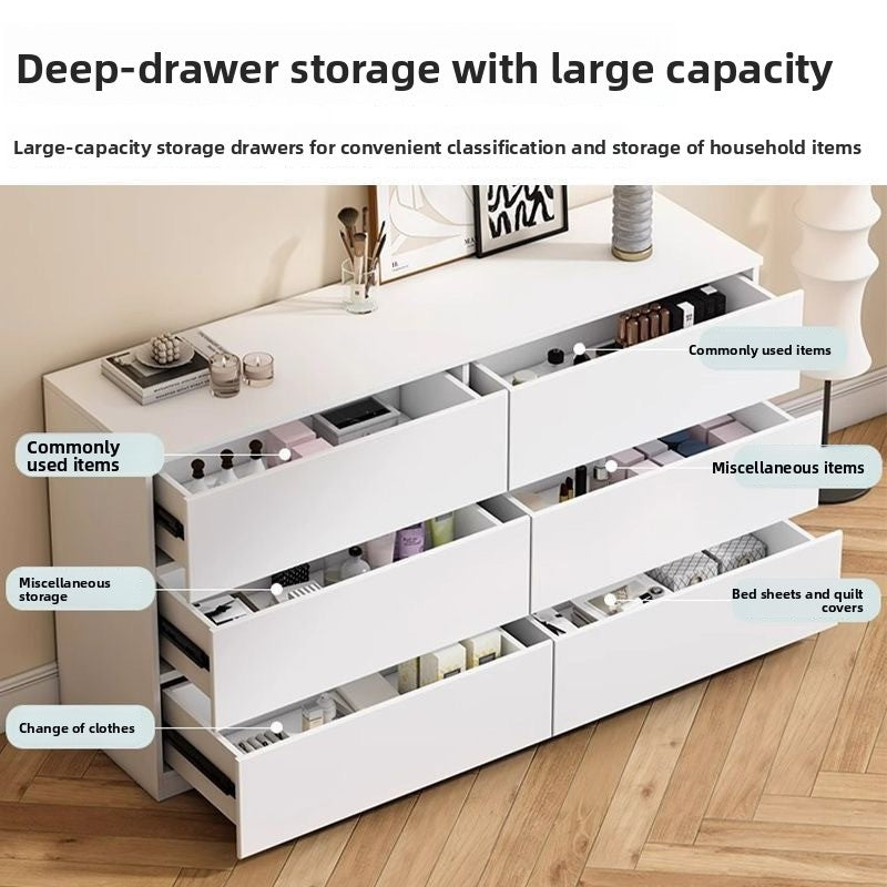 Tall cream dresser with multiple drawers in a modern bedroom