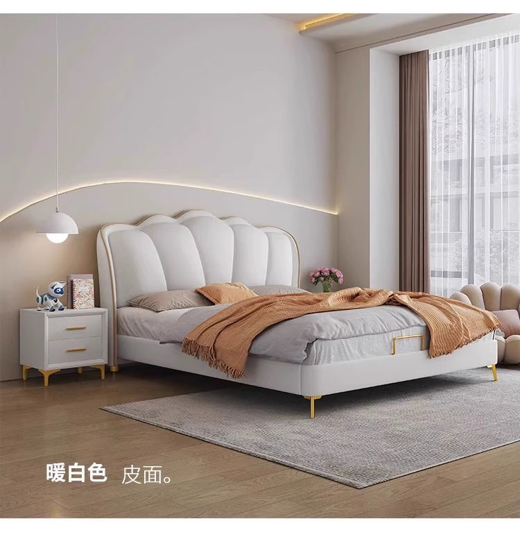 Soft cream statement bed with sculpted headboard and polished bedding