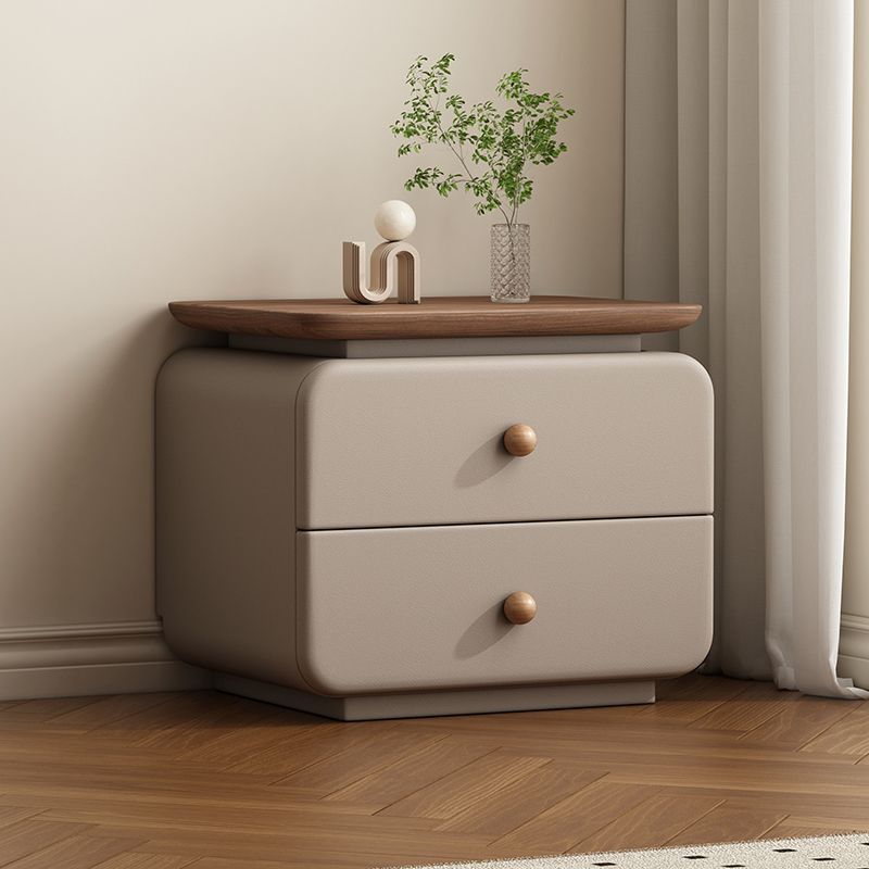Neutral upholstered bedside table with a clean soft-edged silhouette
