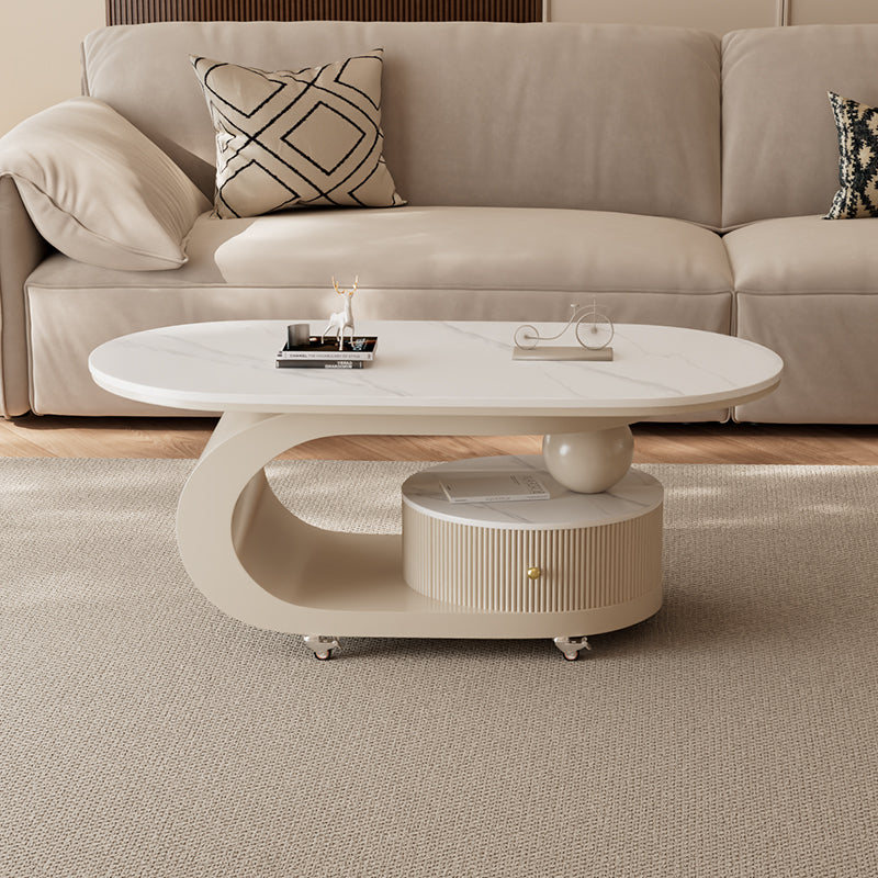 Oval cream coffee table with smooth curved base and slate-look top