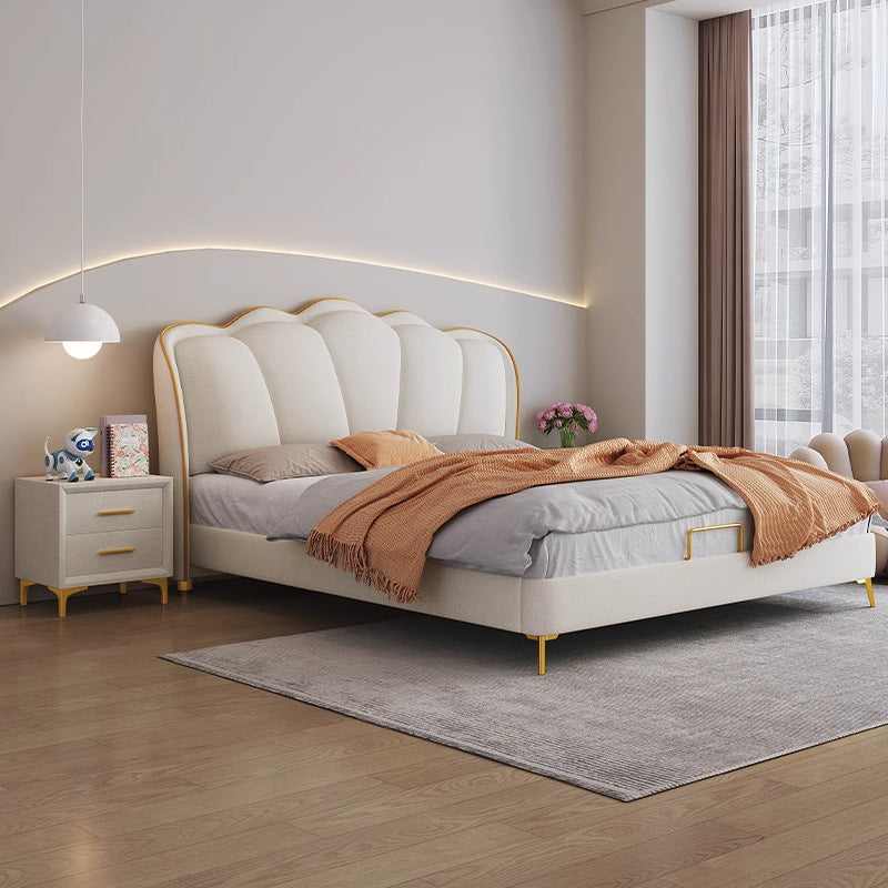Cream sculptural bed with a plush headboard in a refined bedroom