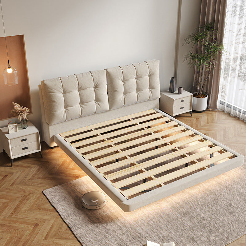 Cream upholstered storage bed styled with modern bedside decor