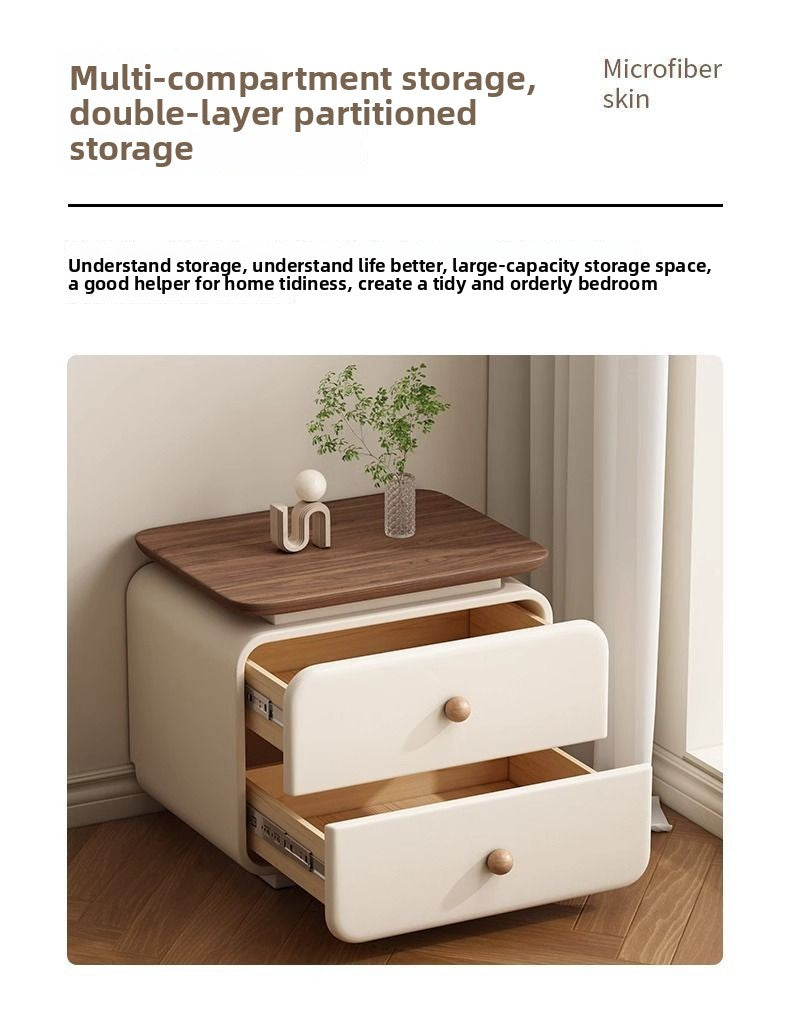 Modern upholstered nightstand with wood drawer accent in a cozy bedroom
