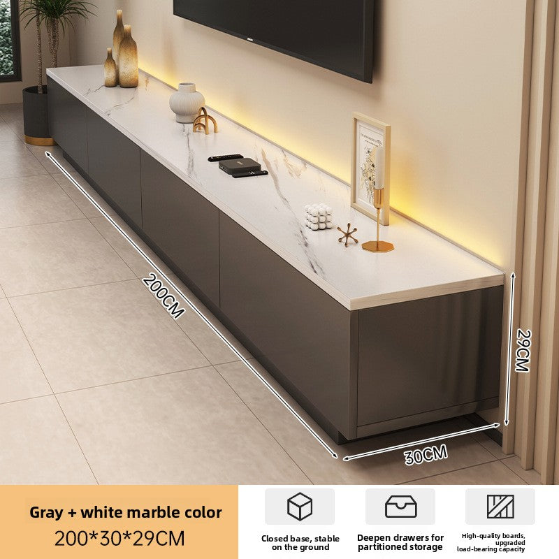 Rounded TV stand in cream finish beneath a clean modern wall setup