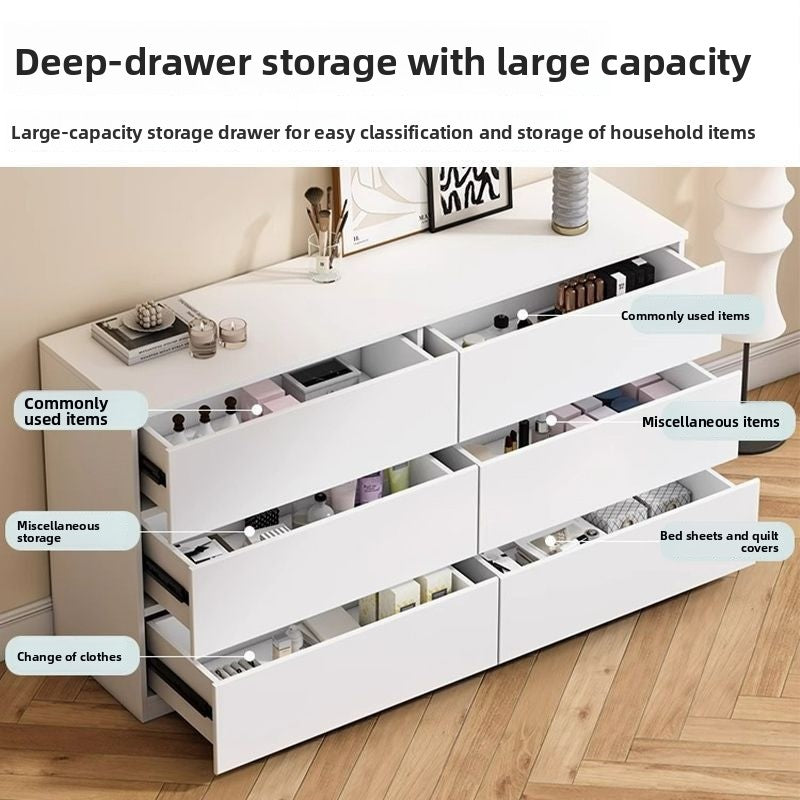Compact cream dresser with smooth drawer fronts in a bright bedroom