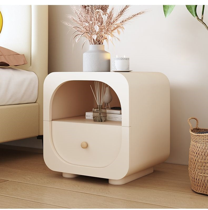 Modern cream nightstand photographed in a bright tidy bedroom corner