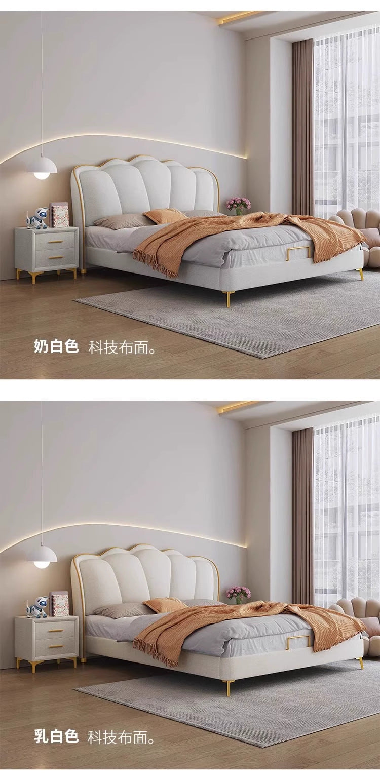 Neutral upholstered bed shown with sculpted headboard and warm decor