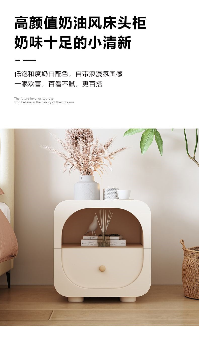 Compact cream bedside table with a glass drawer front and soft neutral styling
