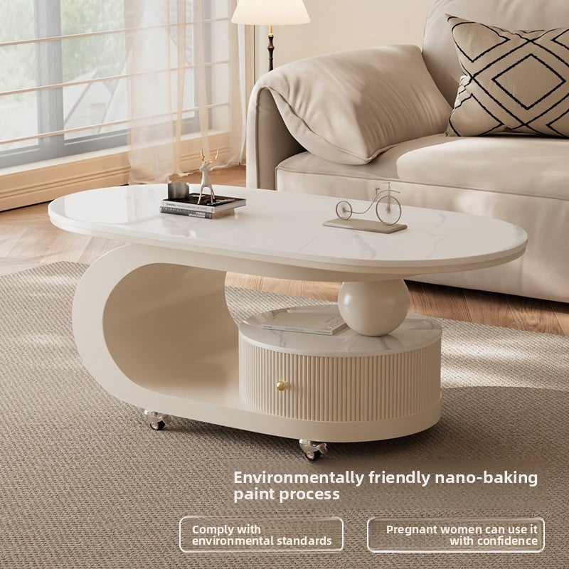 Compact oval coffee table styled for a soft neutral living room