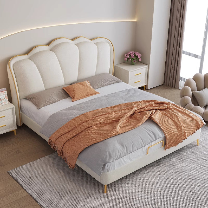 Cream upholstered bed frame with sculptural winged headboard